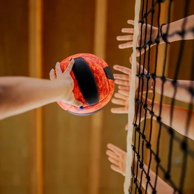 volleyball being played by the net
